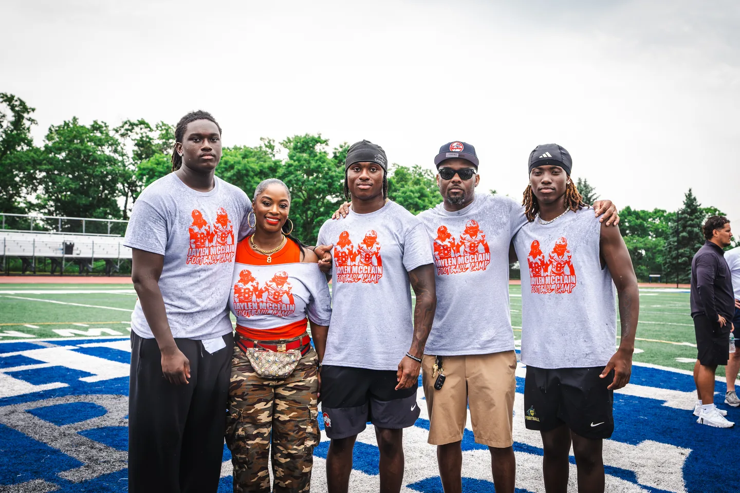 Jaylen McClain poses with camp staff and family on the field at the Jaylen McClain Youth Football Camp.