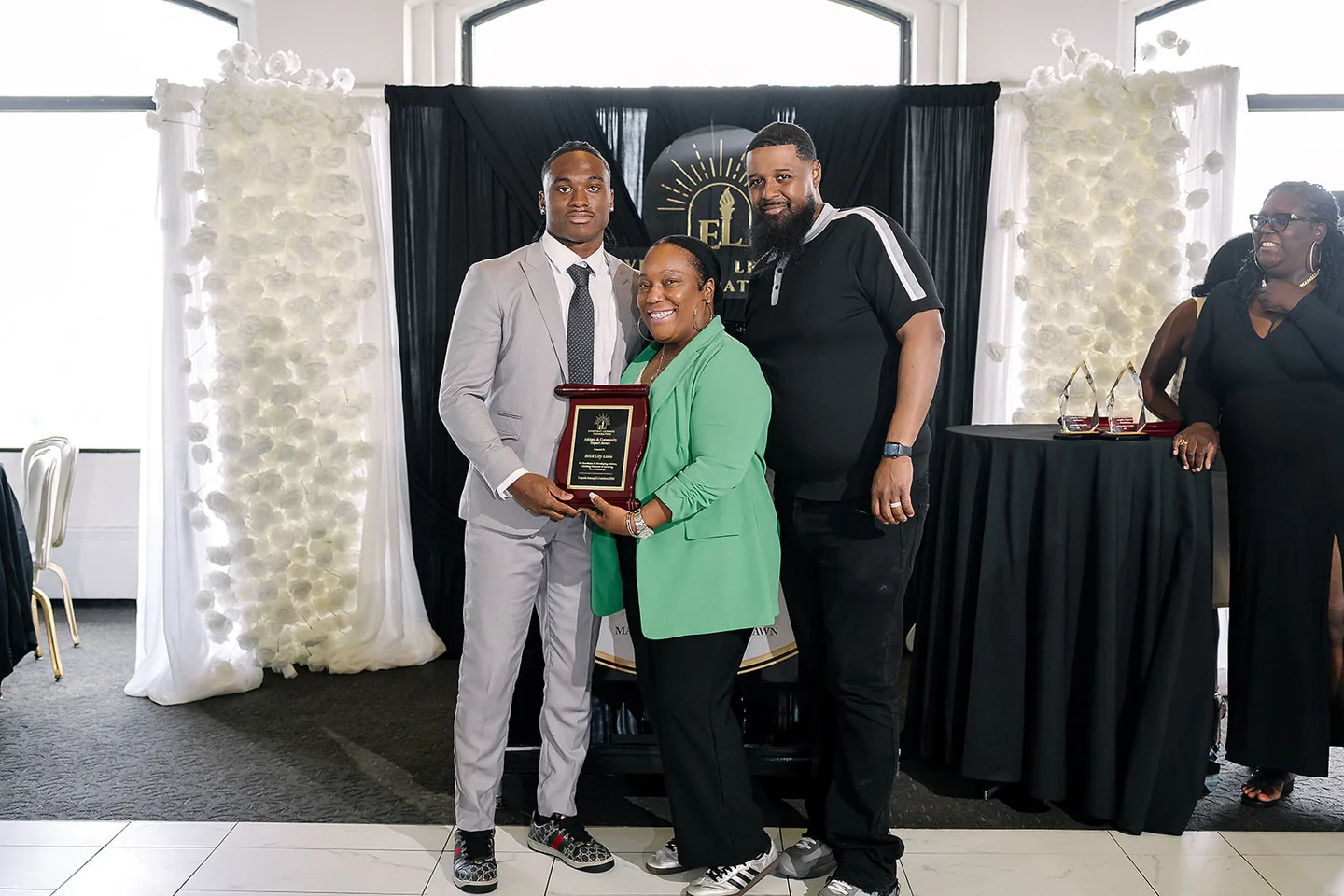 Jaylen McClain presents the Athletic & Community Impact Award to Brick City Lions.
