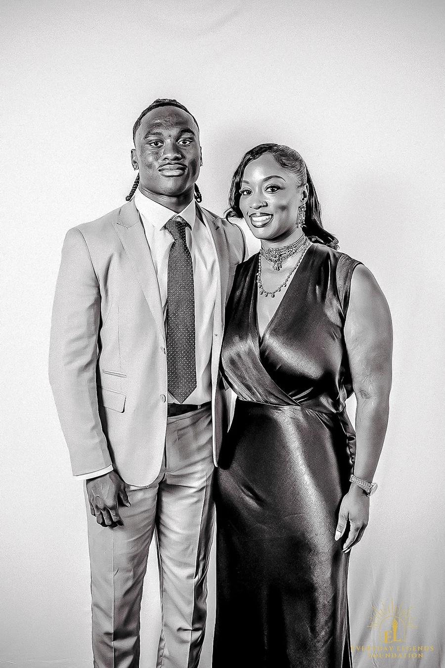 Jaylen McClain with family, black-and-white portrait at a formal event.