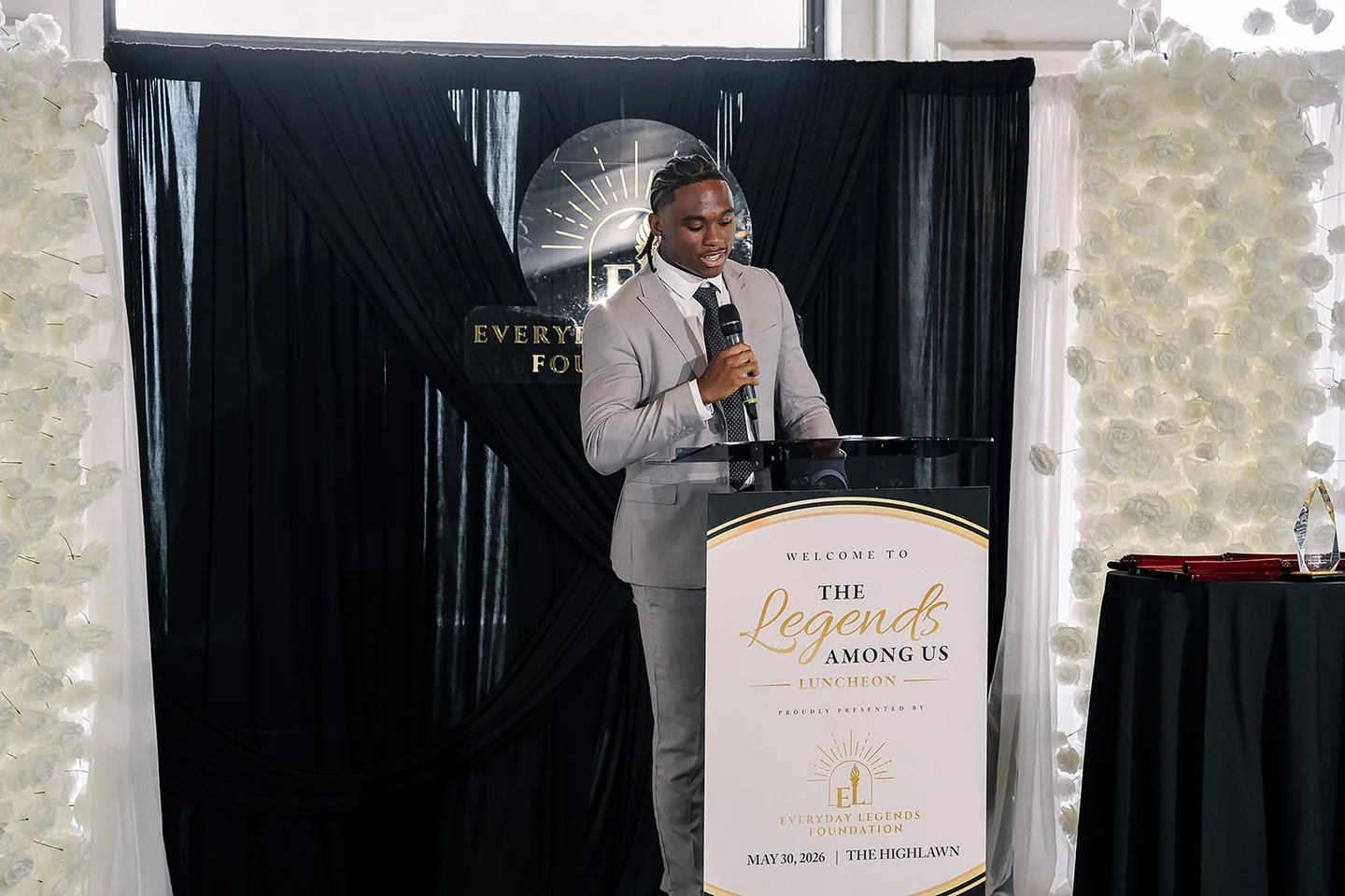Jaylen McClain speaks from the podium at the Legends Among Us Luncheon, May 30, 2026, at The Highlawn.