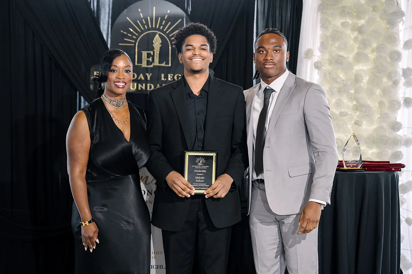 Jaylen McClain presents a Hometown Hero Scholarship to Malcolm Jackson.