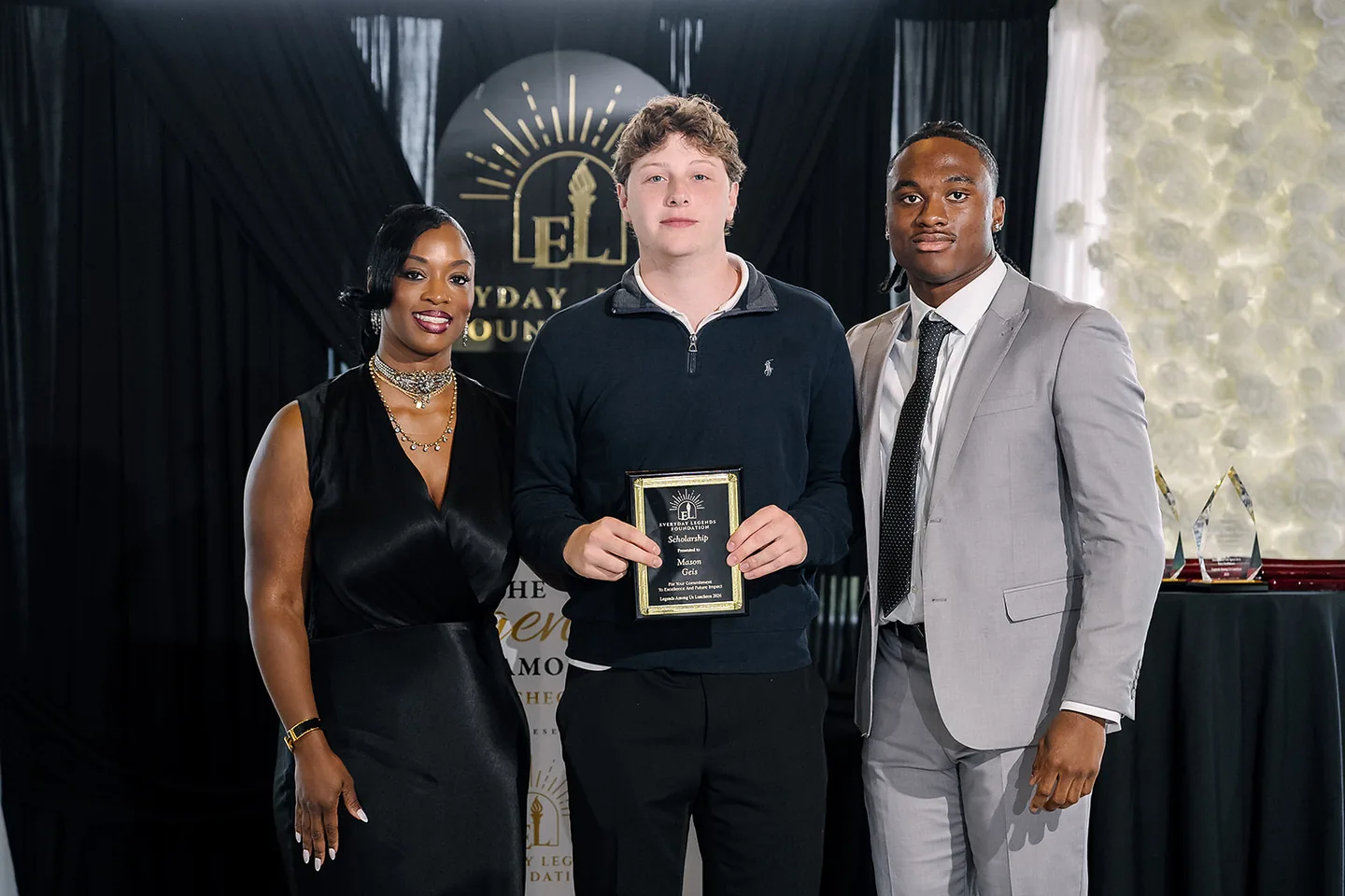 Jaylen McClain presents a Hometown Hero Scholarship to Mason Geis.