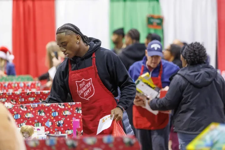 Jaylen McClain sorts wrapped gifts at the Salvation Army of Central Ohio toy drive.