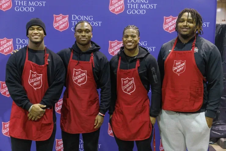 Jaylen McClain and his Ohio State teammates in Salvation Army aprons at the toy drive.